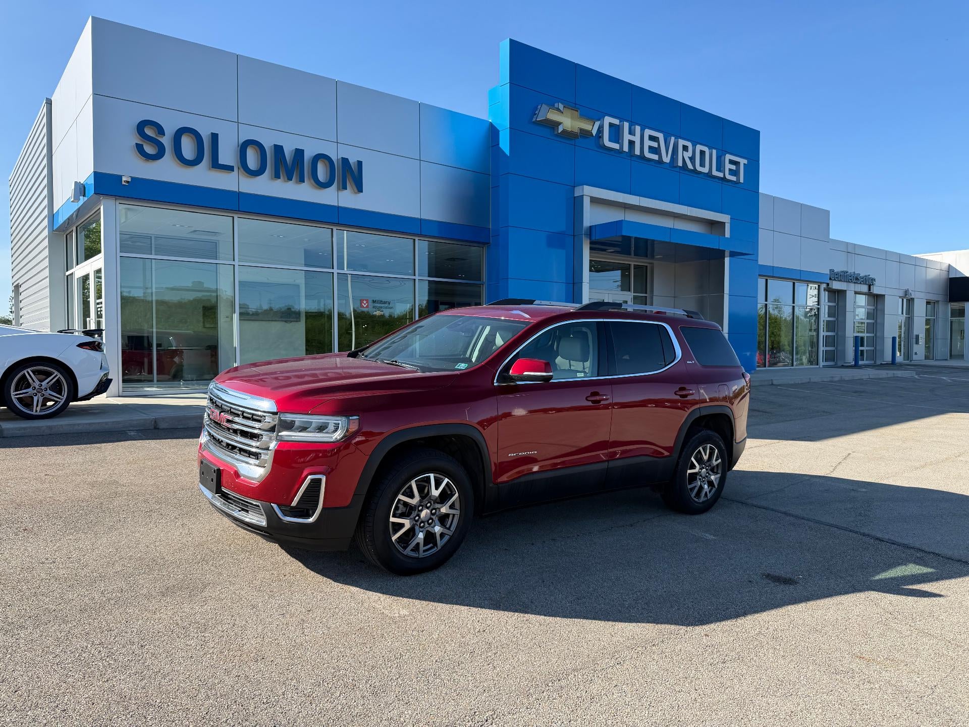 2023 GMC Acadia SLT in Volcanic Red Tintcoat — front three-quarter view