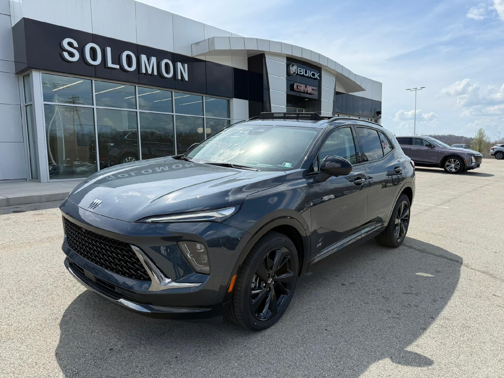 2026 Buick Envision Sport Touring in Quartz Blue Metallic — front three-quarter view